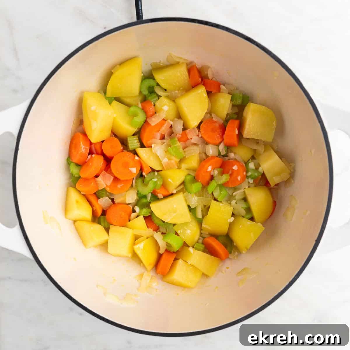 Hearty Vegan Beef-Style Stew with Plant-Based Chunks 5 Vegetables sautéed in olive oil in a large pot.