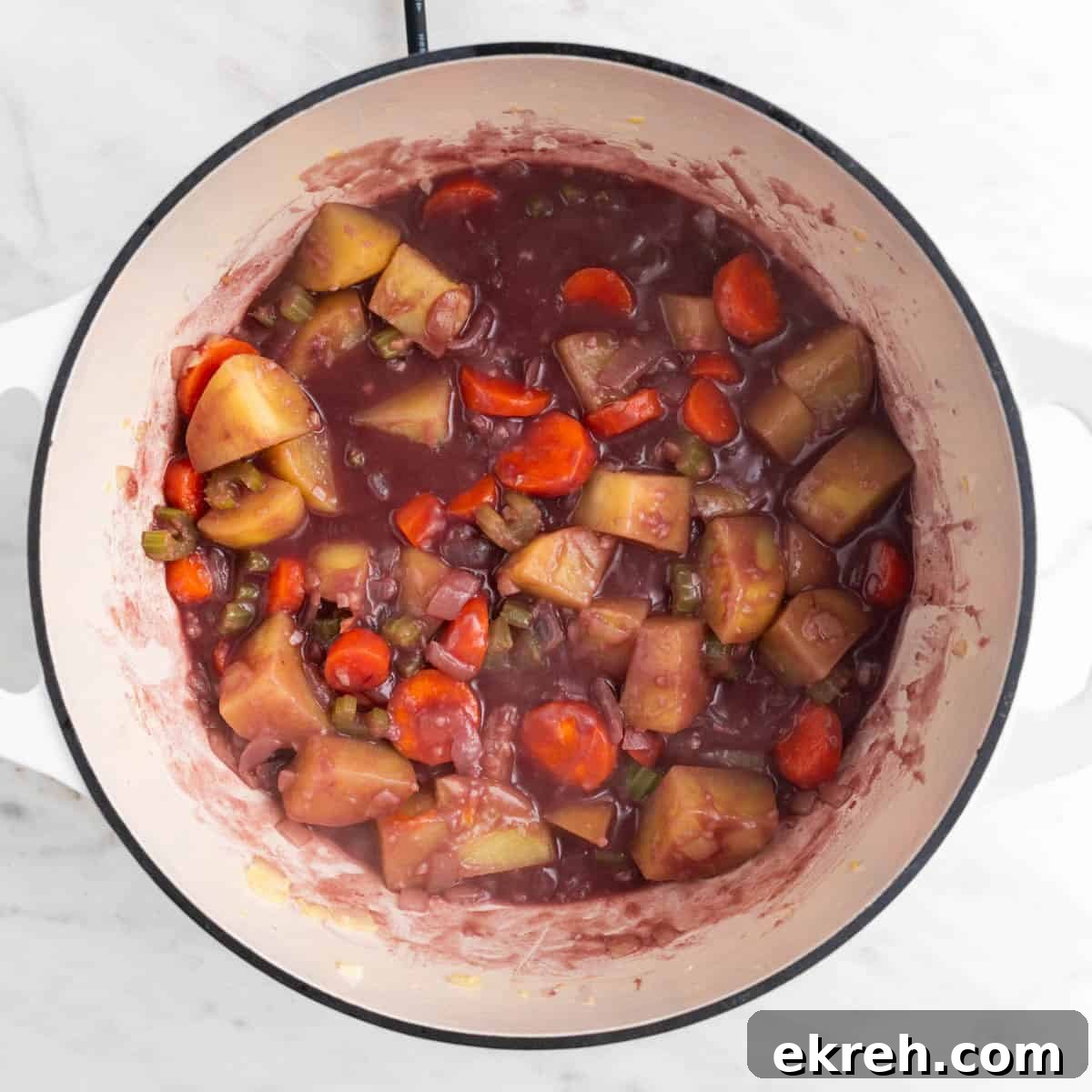 Hearty Vegan Beef-Style Stew with Plant-Based Chunks 7 Vegetables sautéed in olive oil with flour and red wine added.