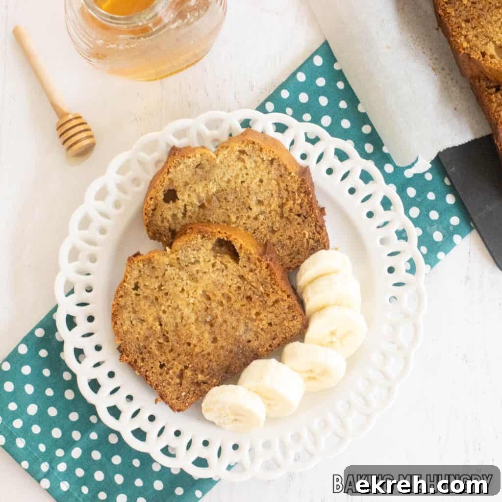 honey banana bread slices on plate close up with extra bananas