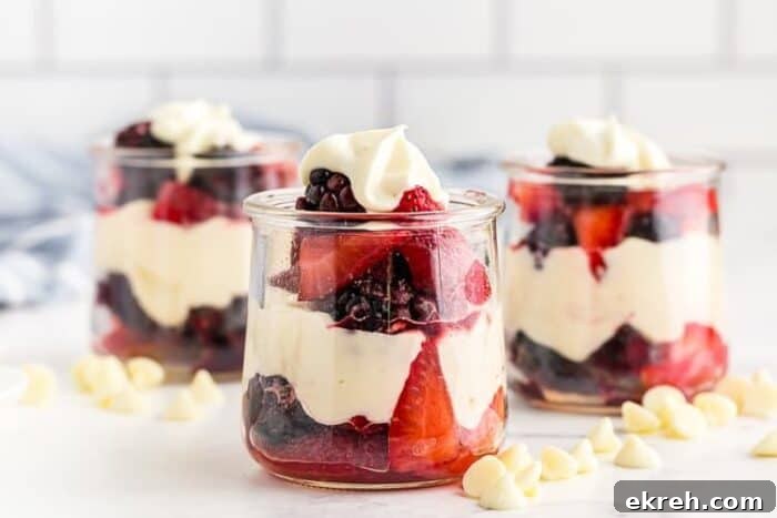 3-Ingredient Keto Whipped Cream Recipe 18 three glass jars containing keto white chocolate mousse layered with berries