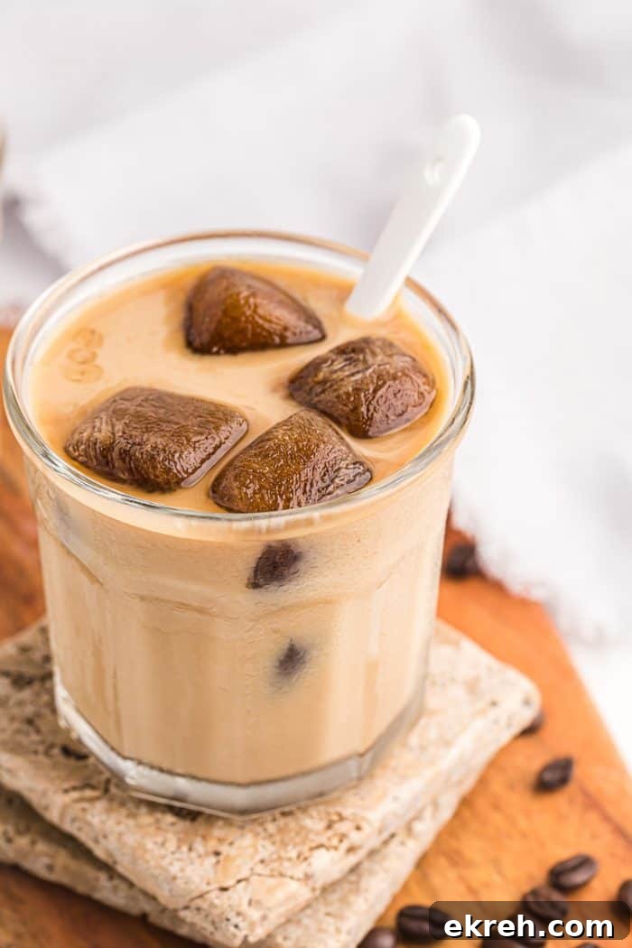 3-Ingredient Keto Whipped Cream Recipe 6 side view of glass of keto iced coffee with cubes melting in milk