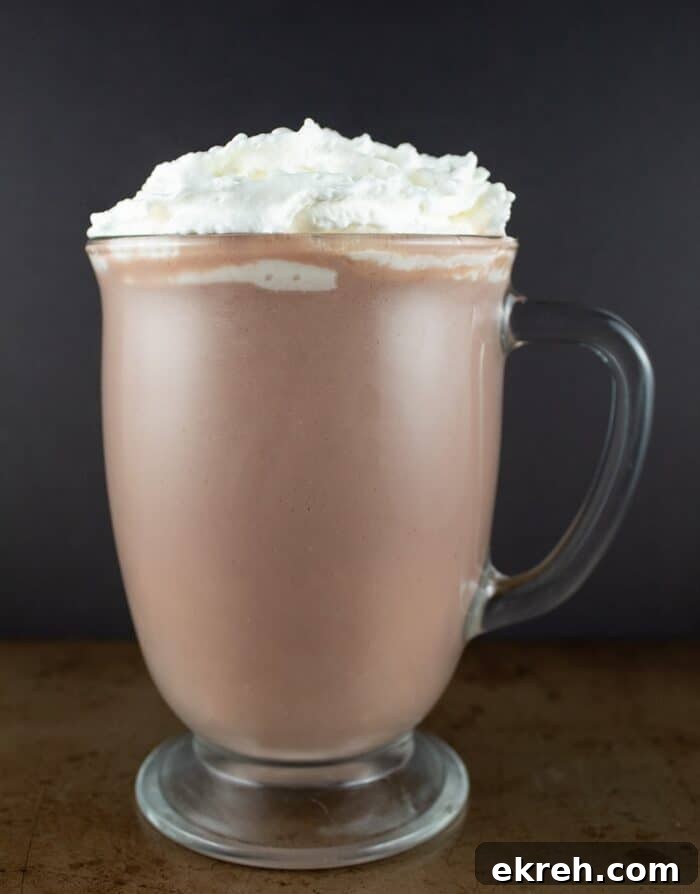 3-Ingredient Keto Whipped Cream Recipe 10 keto hot chocolate against a black background with a ton of whipped cream on top