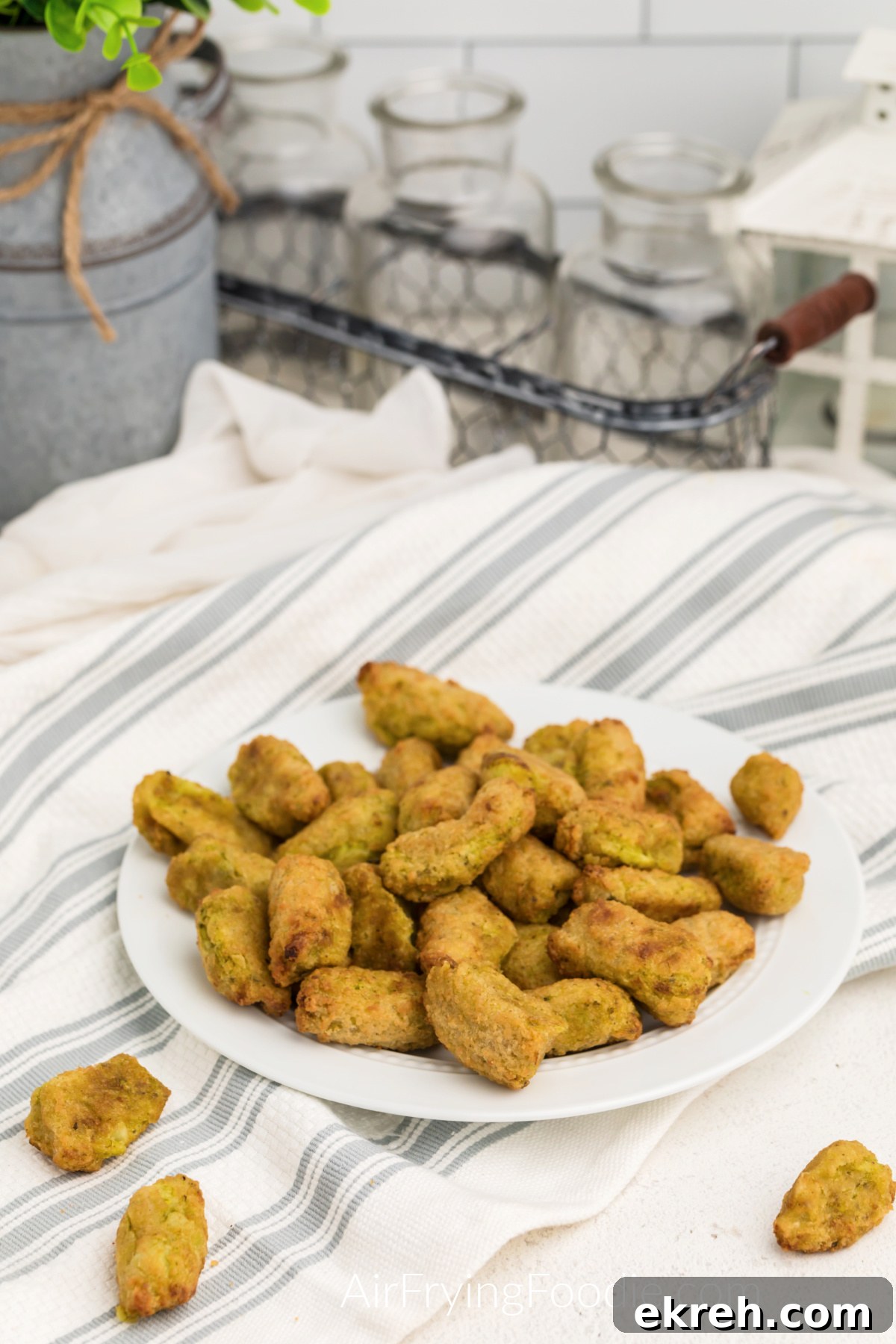 Air fried veggie tots on a white plate, ready to serve.