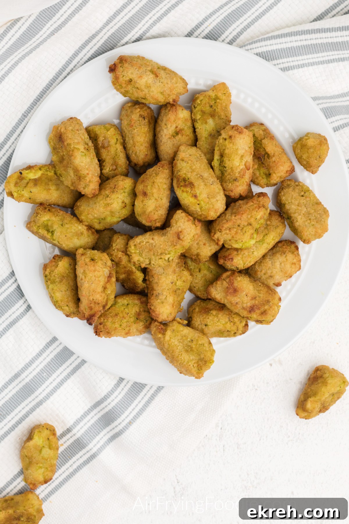 Overhead photo of air fried veggie tots on a white plate, ready to serve.