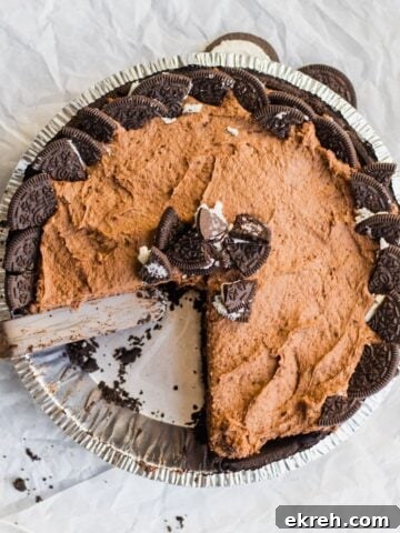 chocolate pudding pie with a slice removed, garnished with crushed oreos