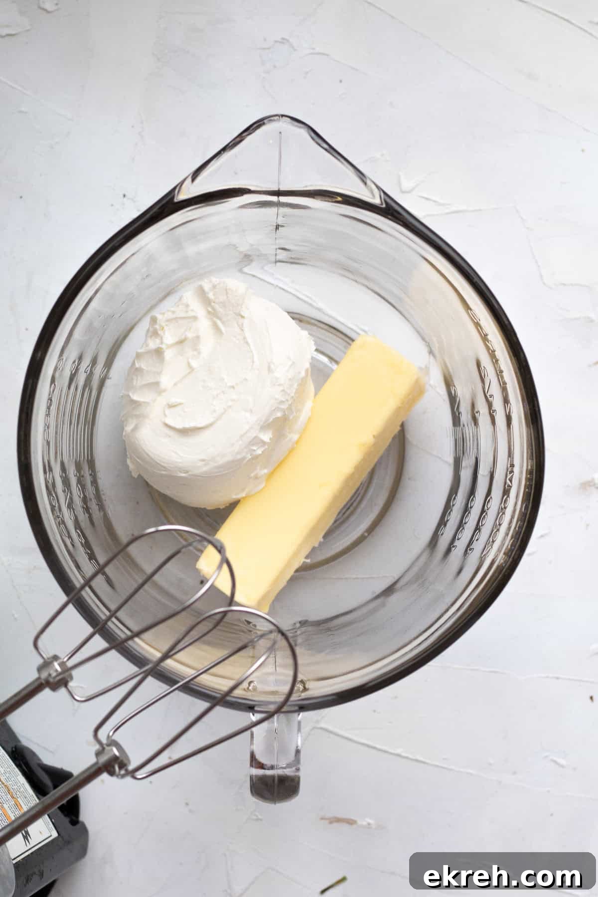 cream cheese and butter in a glass mixing bowl