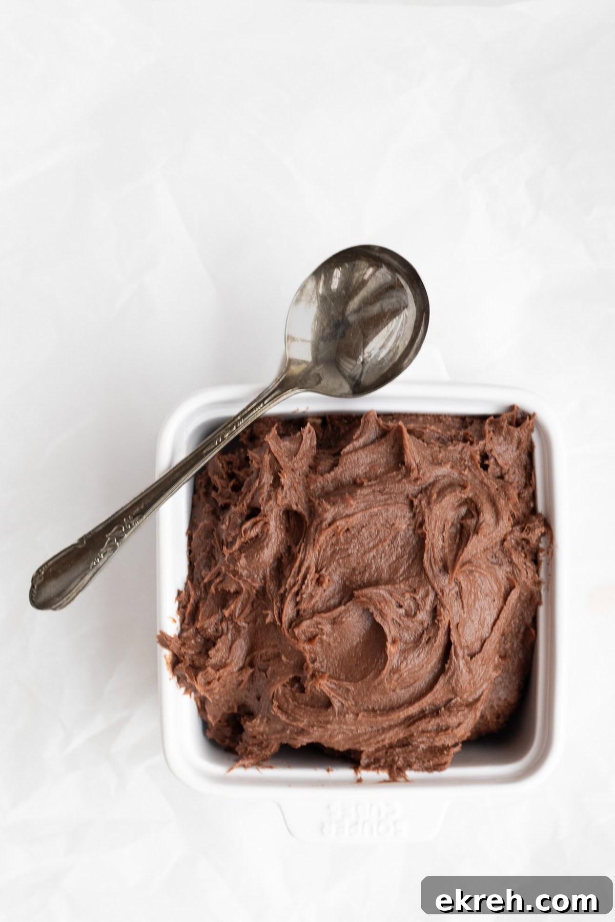 brownie batter in a bowl with a spoon.
