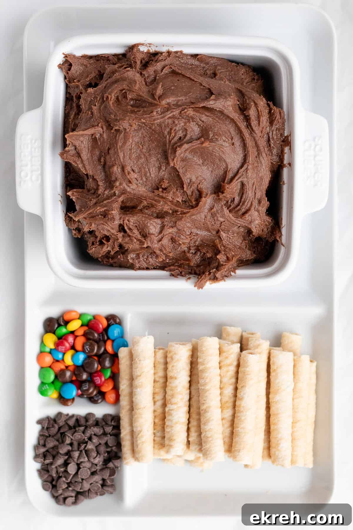 brownie dip with add-ins and dippers on a platter