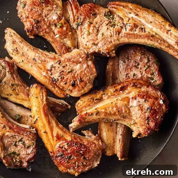 A pile of perfectly cooked Lamb Chops in a pan, ready to serve.
