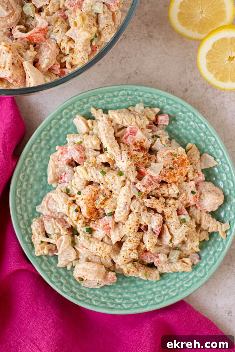 Shrimp and Calamari Seafood Salad with Lemon Vinaigrette 4 A plate filled with seafood salad for serving. A hlaved lemon sits to the side.