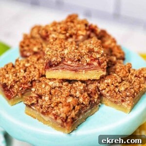 stack of apple pie bars on a light blue cake pedestal