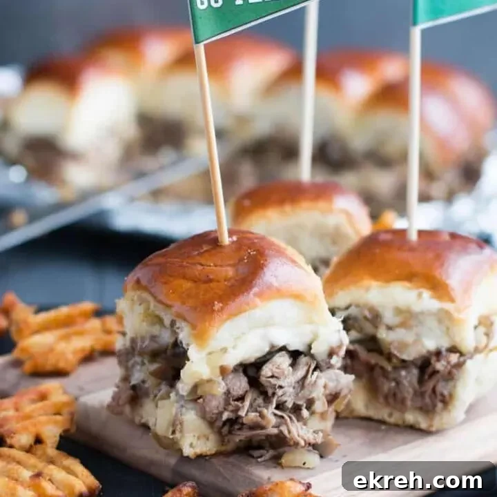 Philly Cheesesteak Sliders. Tender shaved steak, fried onions and mushrooms, melty cheese and a buttery toasted bun make these sliders a delicious choice for game day. Free printable pennants make them fun!