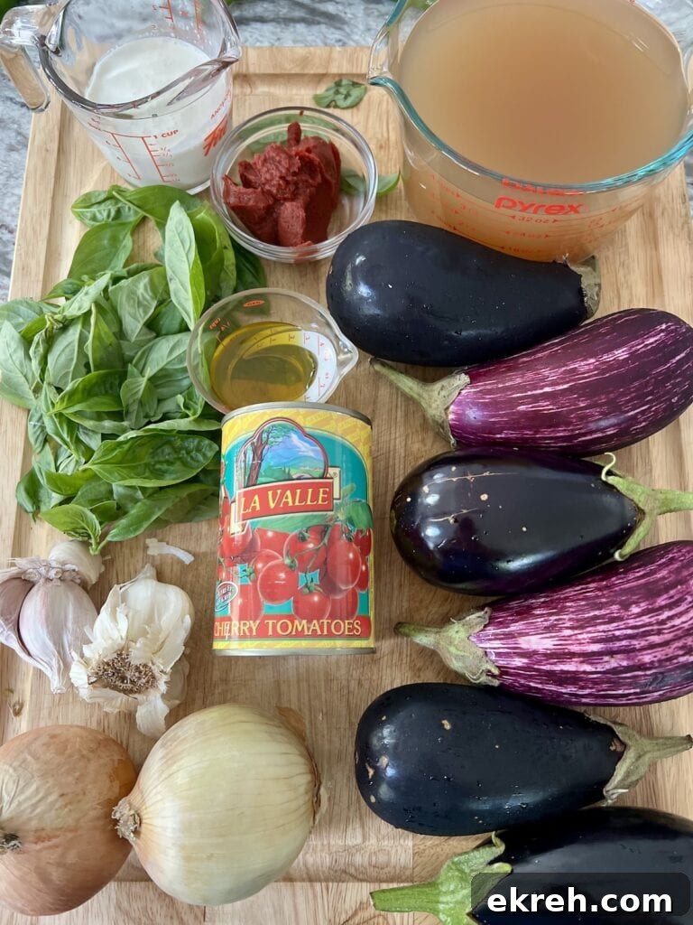 All ingredients for creamy eggplant soup recipe on cutting board.