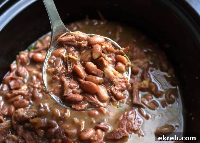 Pinto Beans and Ham in slow cooker with ladle