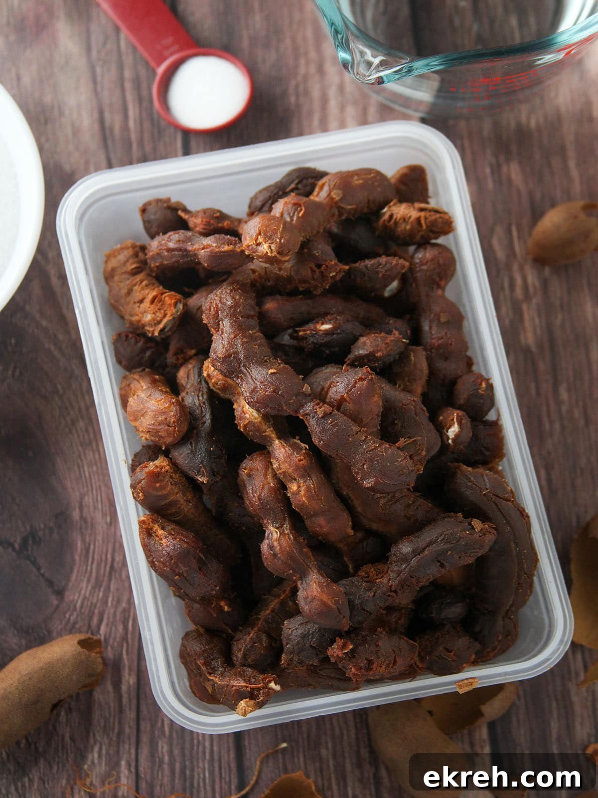 Sampalok Candy: Sweet Tangy Filipino Tamarind Treat 4 peeled tamarind pods in a plastic container