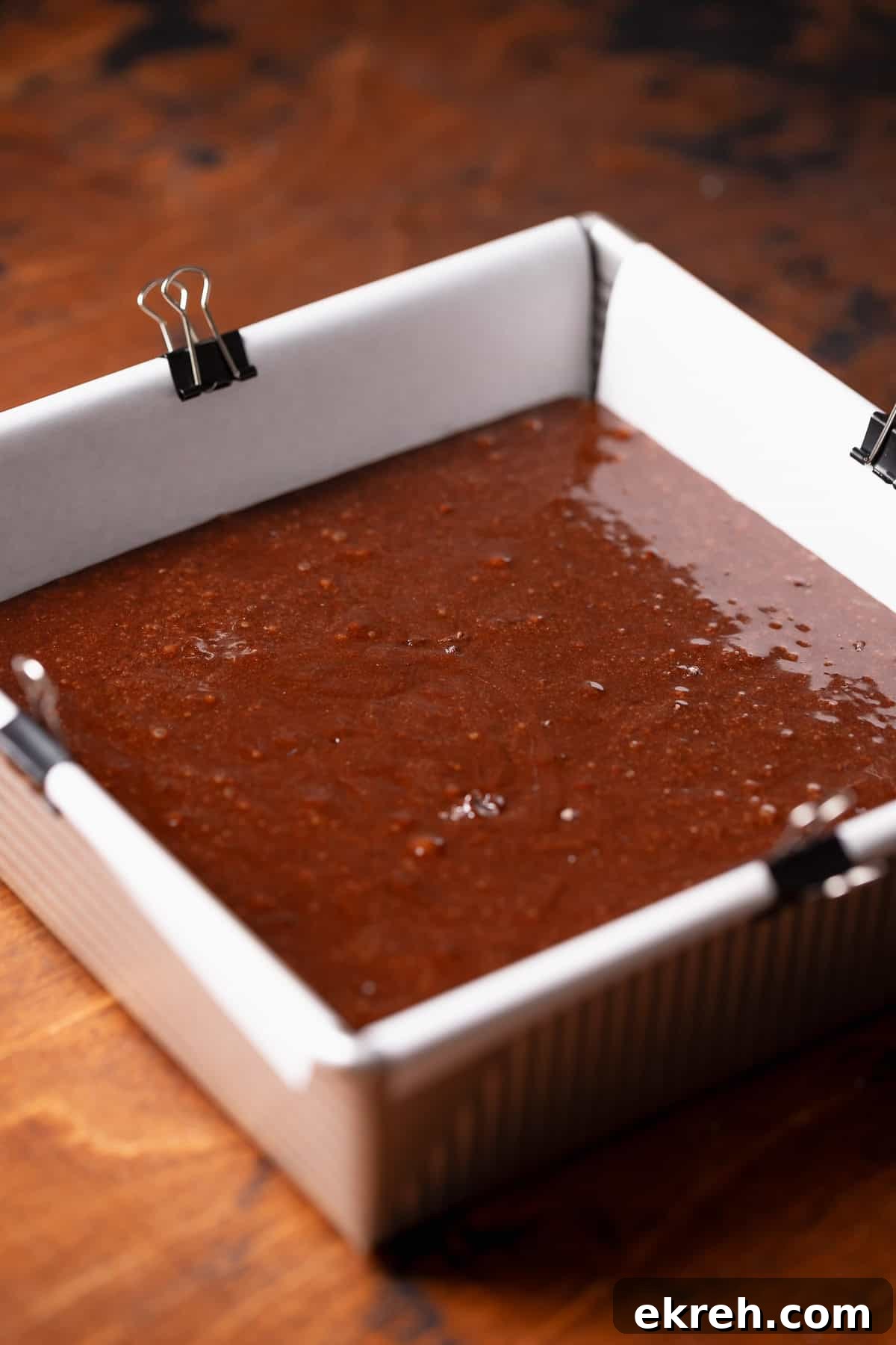 A square pan with the brownie batter before baking.