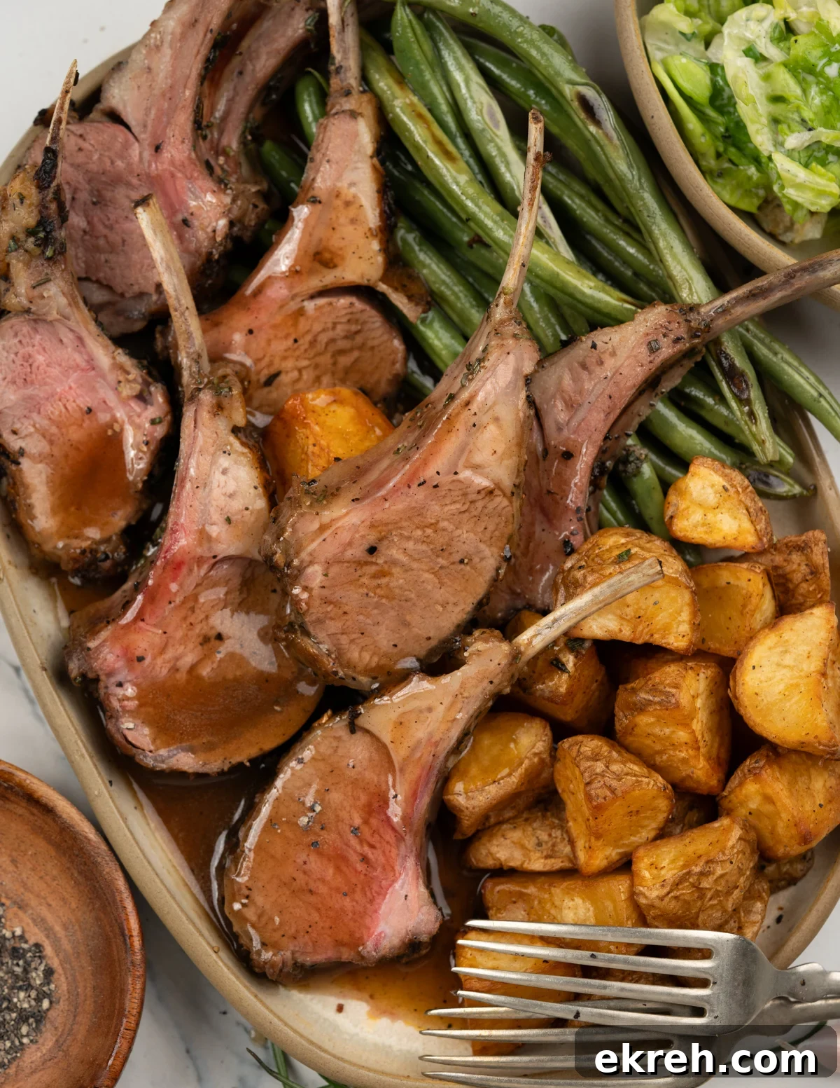 Carved lamb chops from a rack of lamb and served with gravy.