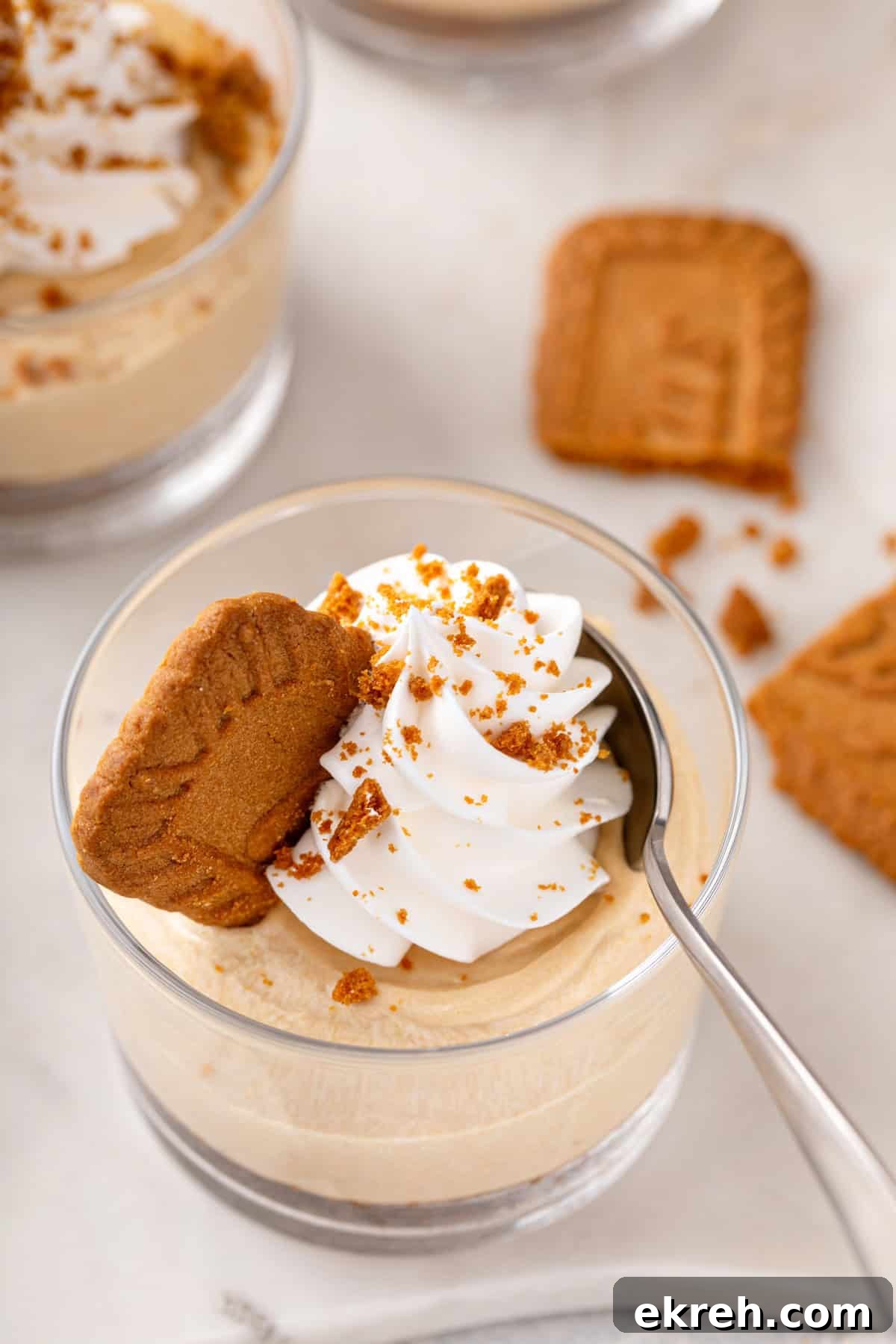 Spoon in a ramekin of no-bake biscoff cheesecake.