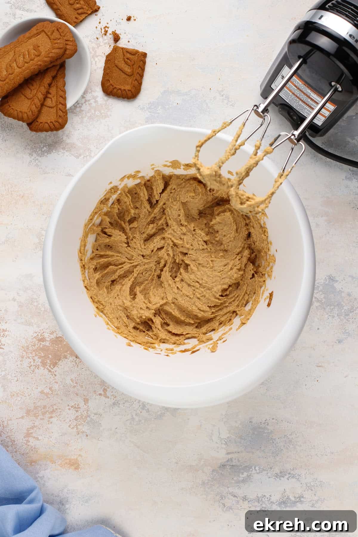 Cream cheese and biscoff spread mixed in a white bowl.