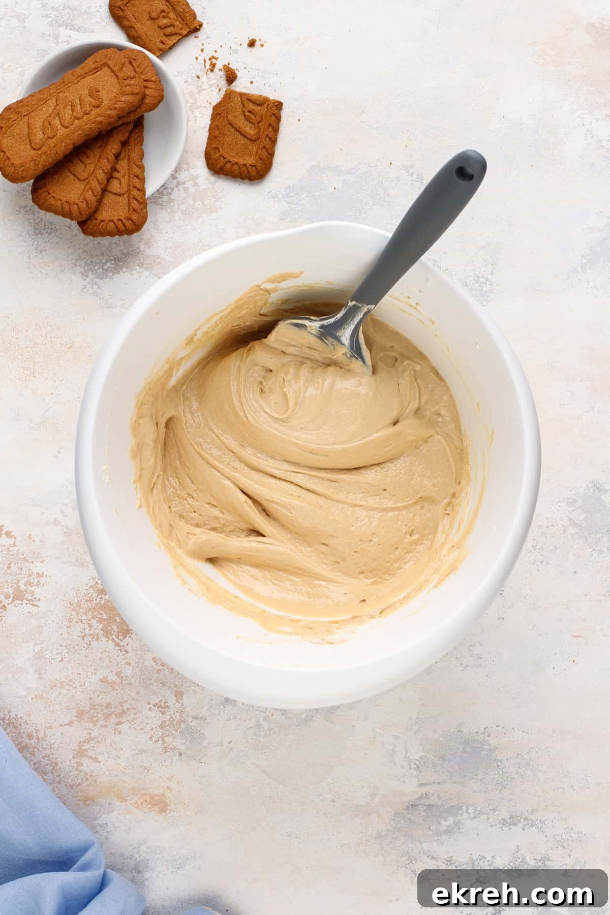 Biscoff cheesecake filling mixed in a white bowl.