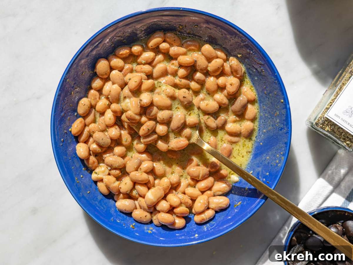 Step 2 Pinto beans mixing with dressing in bowl, glossy and well coated.