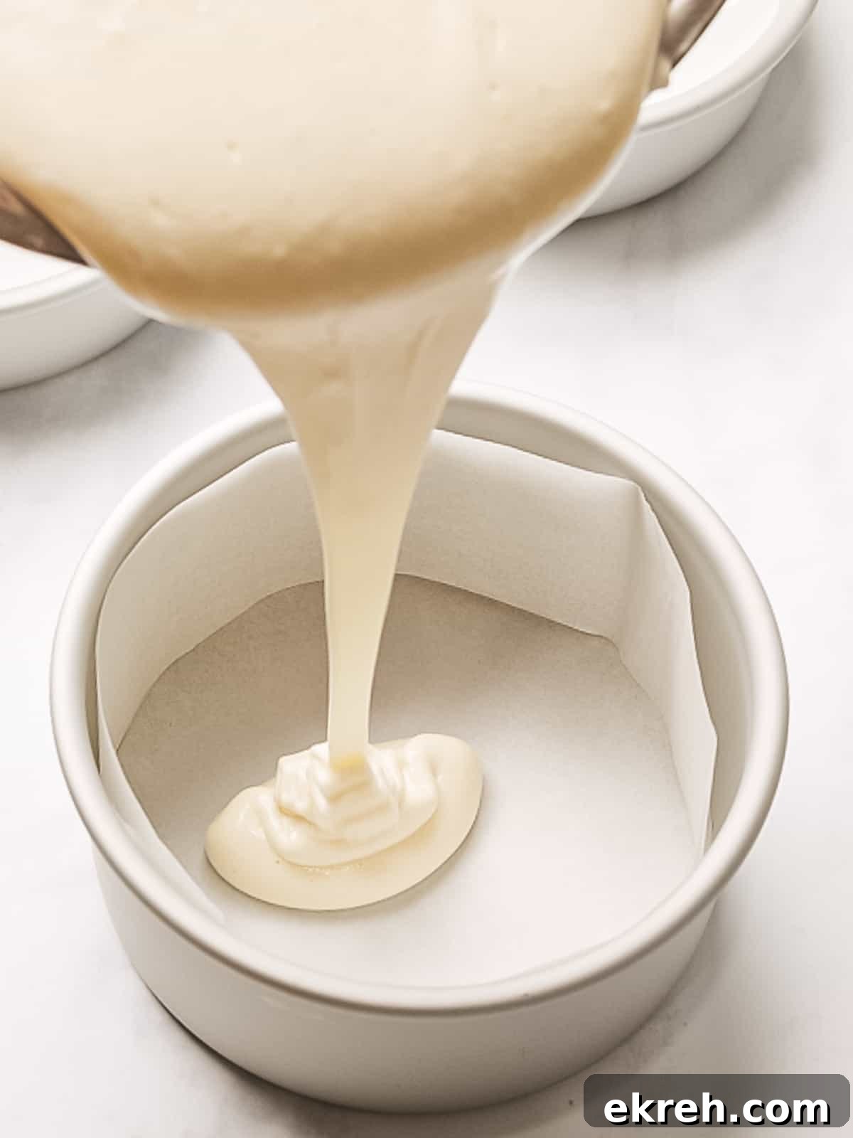 Sponge cake batter poured into a cake pan.