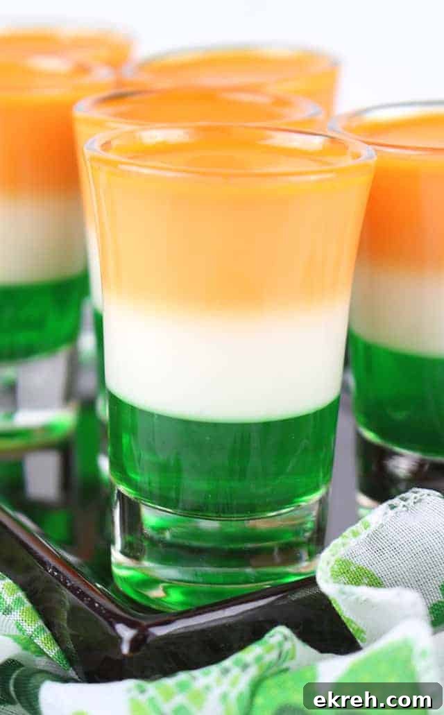 Close up of St. Patrick's Day jello shots on a black plate