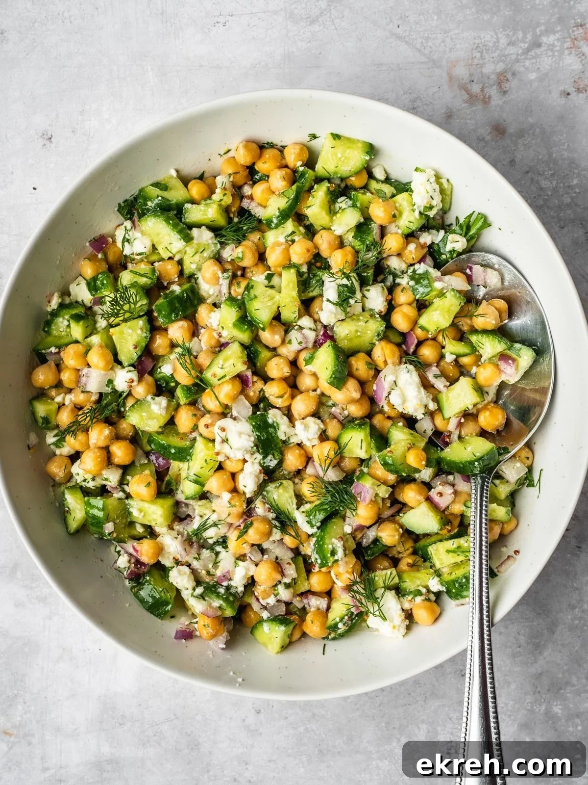 Mediterranean Cucumber, Chickpea and Feta Salad 6 Cucumber chickpea and feta chopped salad in a bowl garnished with dill.