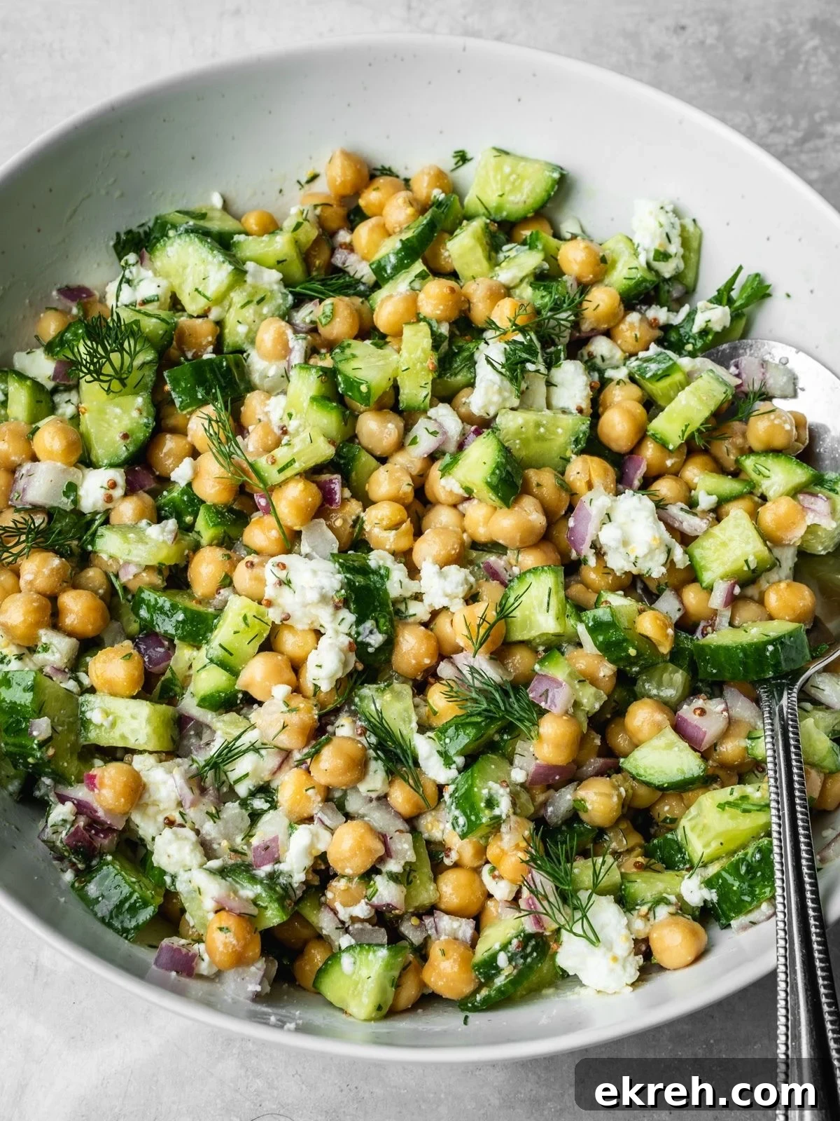 Mediterranean Cucumber, Chickpea and Feta Salad 7 Cucumber chickpea and feta chopped salad in a bowl garnished with dill.
