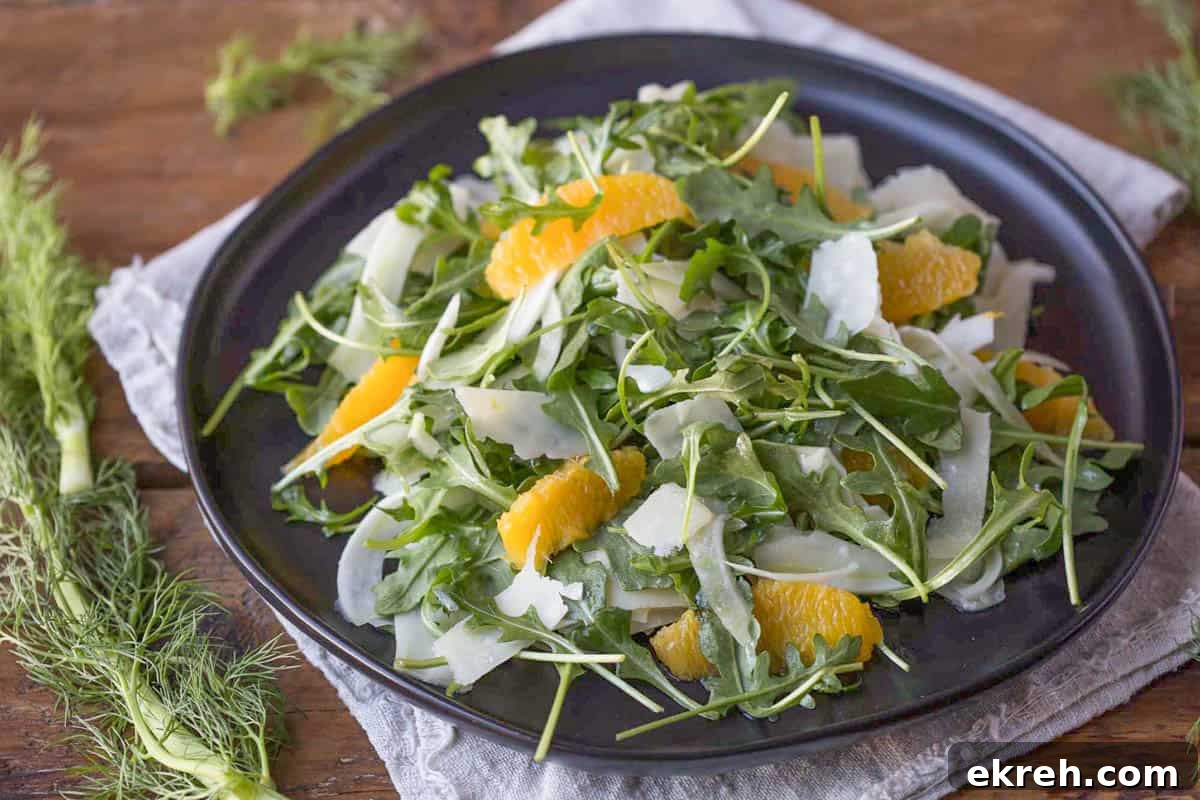 Fennel, Orange and Arugula Salad 3 fennel, arugula, shaved parmesan, and segmented oranges on a black plate.