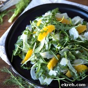 Fennel, Orange and Arugula Salad 5 fennel and arugula salad with orange segments on a black plate.