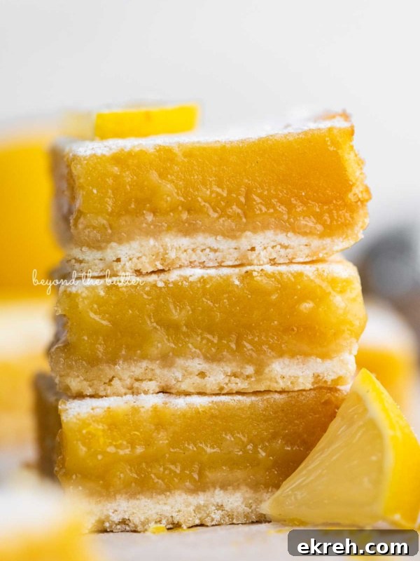 Pumpkin Pie Cake Bars Recipe 8 Stack of three lemon bars on white background.
