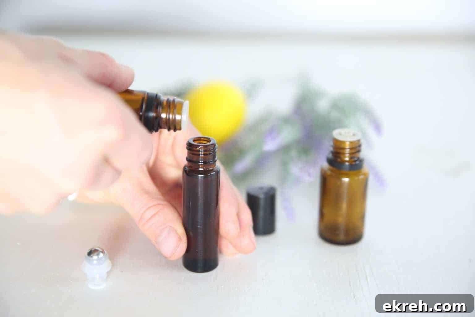 Lemon Lavender Peppermint Roller for Spring Aromatherapy 3 A woman making a lemon lavender and peppermint roller bottle.