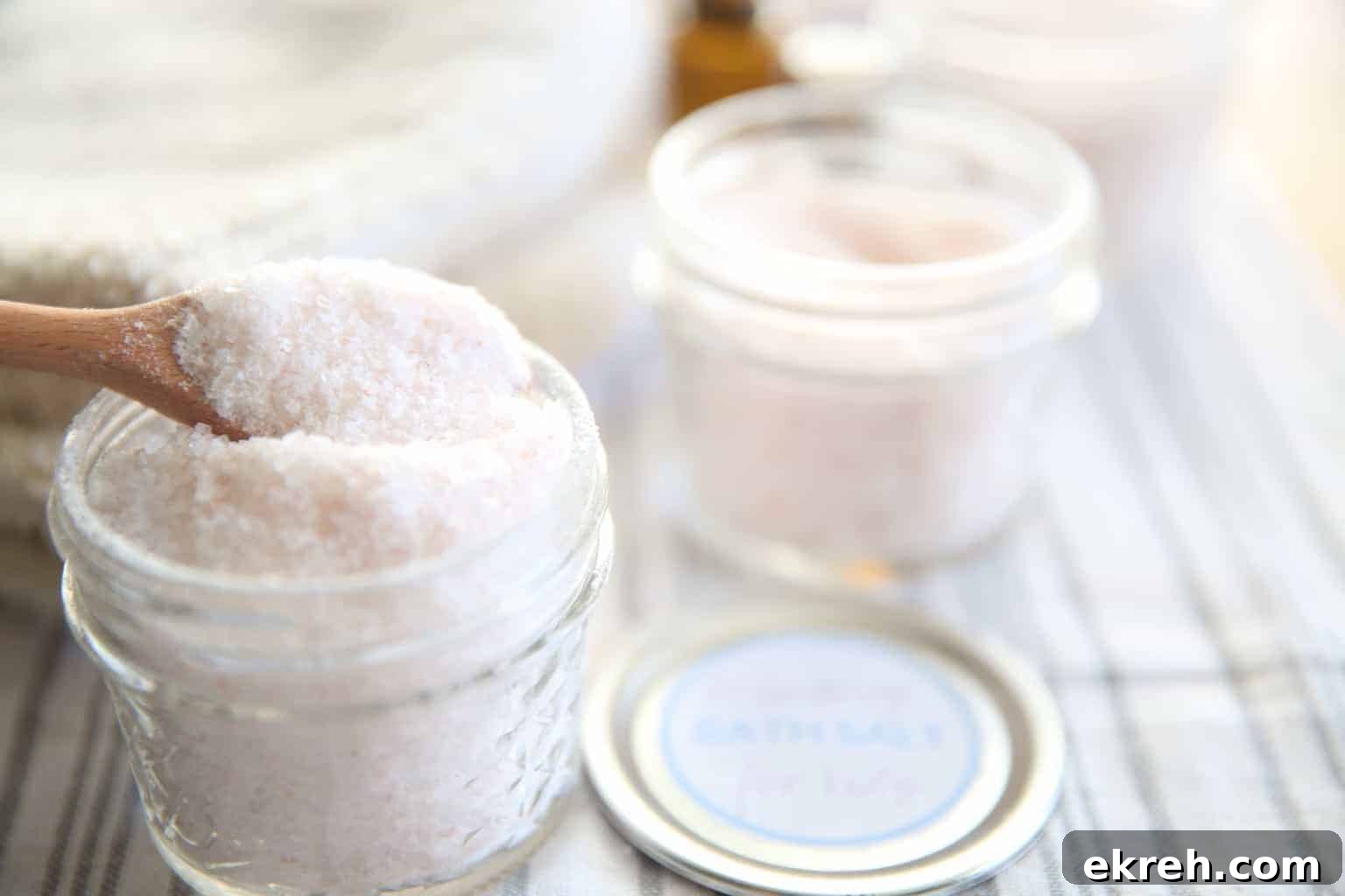 Lemon Lavender Peppermint Roller for Spring Aromatherapy 5 Homemade bath salts with essential oils in small white mason jars.