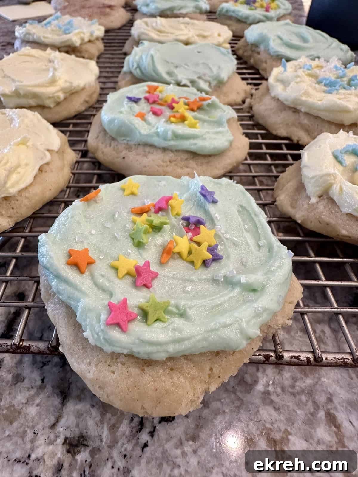 Frosted cookies on a cooling rack.