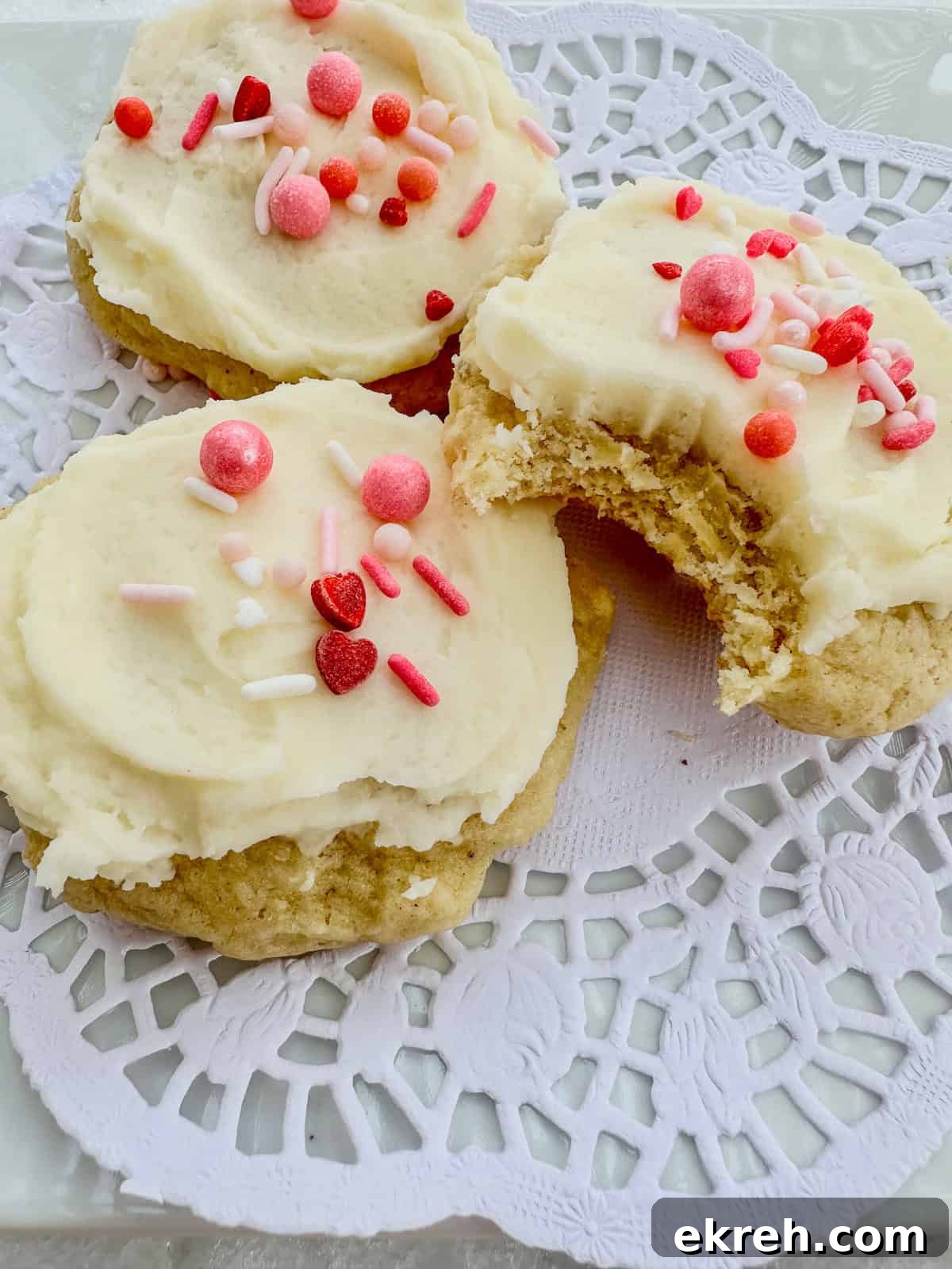 Sour cream cookies and one with a bite mark.