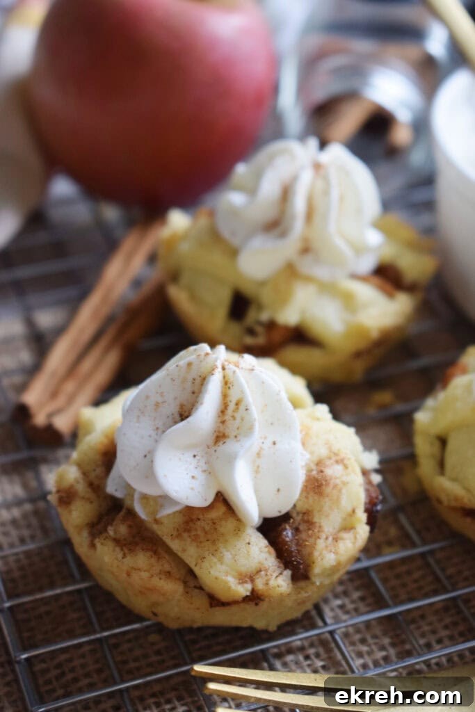 Muffin tin apple pies with cinnamon sticks.