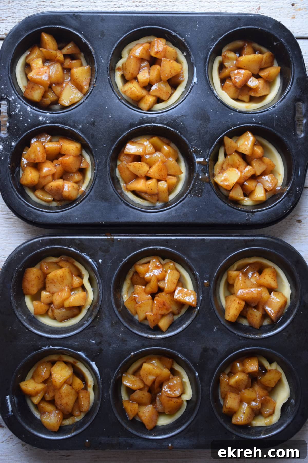 Making mini apple pies in muffin tins.