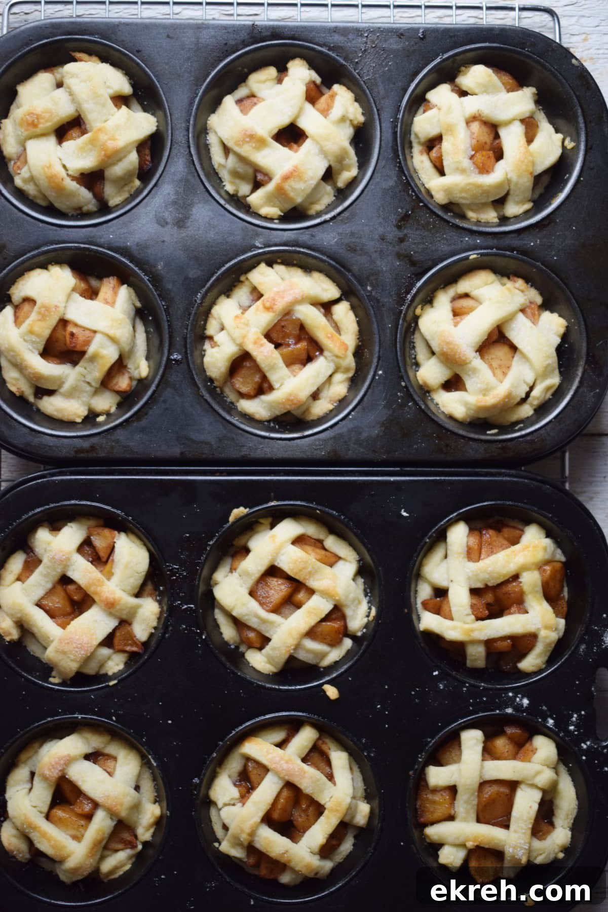 Freshly baked mini apple pies in muffin cups.