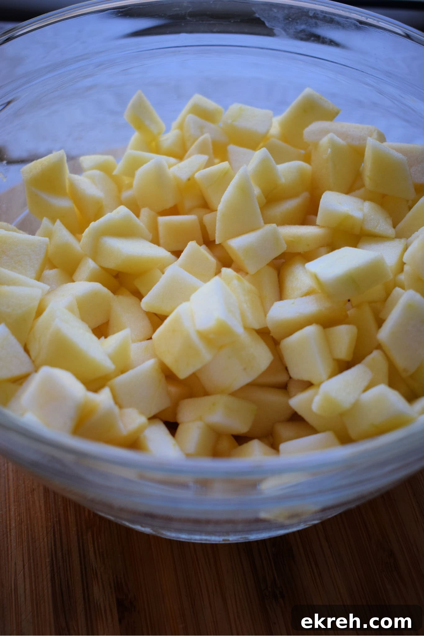 Diced apples in a glass bowl.