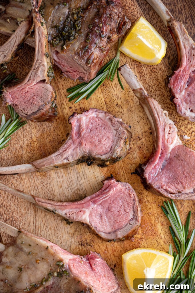 Cut grilled rack of lamb cut and spread out over a wooden cutting board.