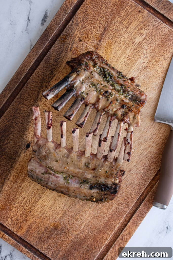The two racks of lambs standing against each other after resting waiting to be cut apart.