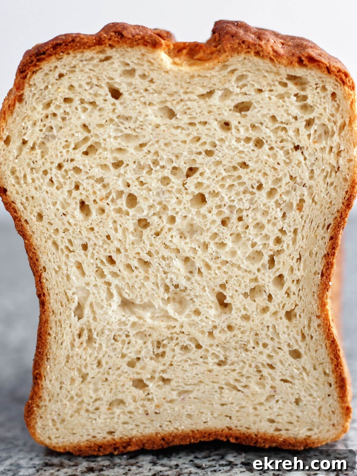 cross section of loaf bread made with multigrain flour.