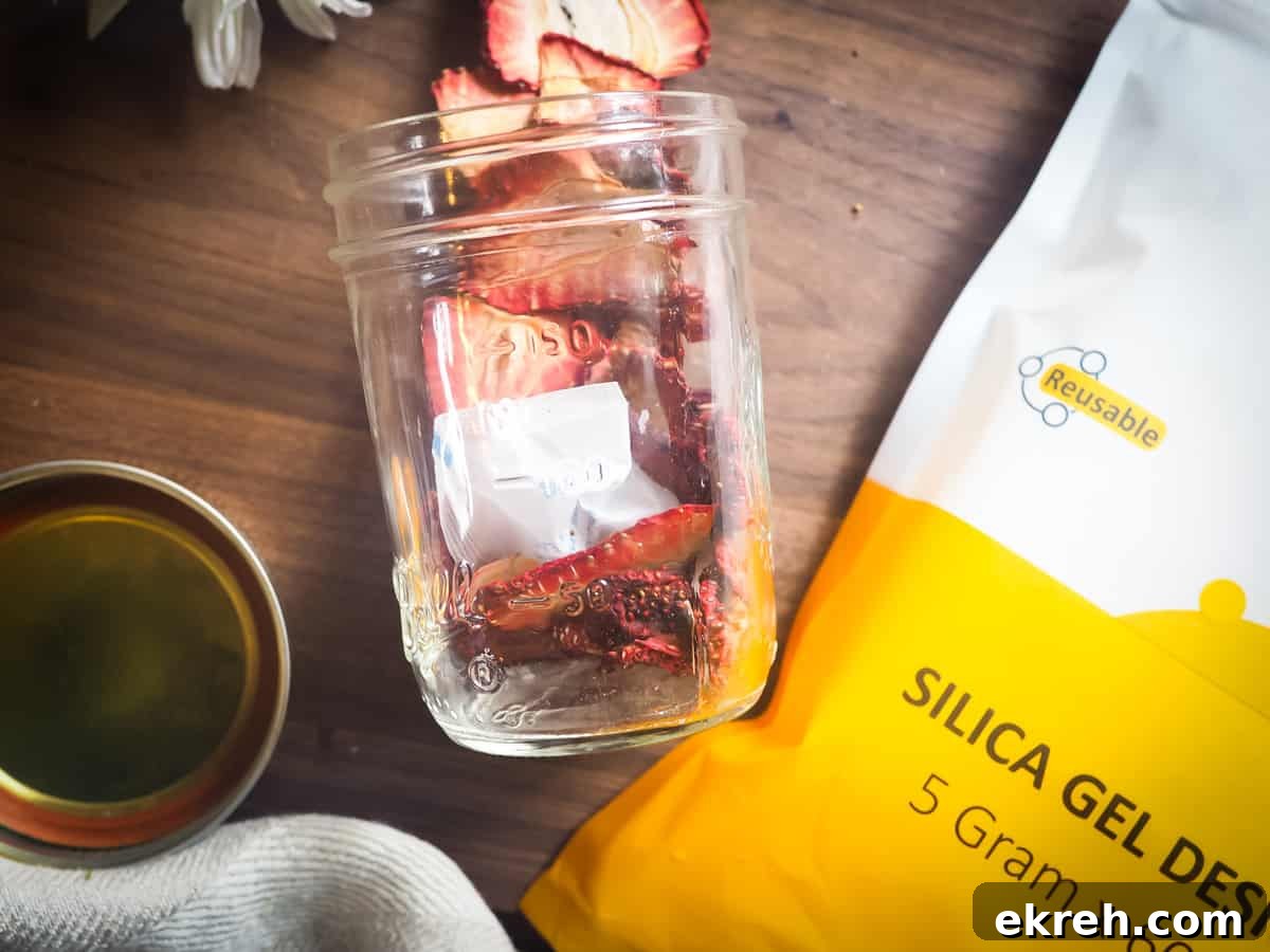 a spilled jar of dehydrated strawberries with a bag of desiccant packs