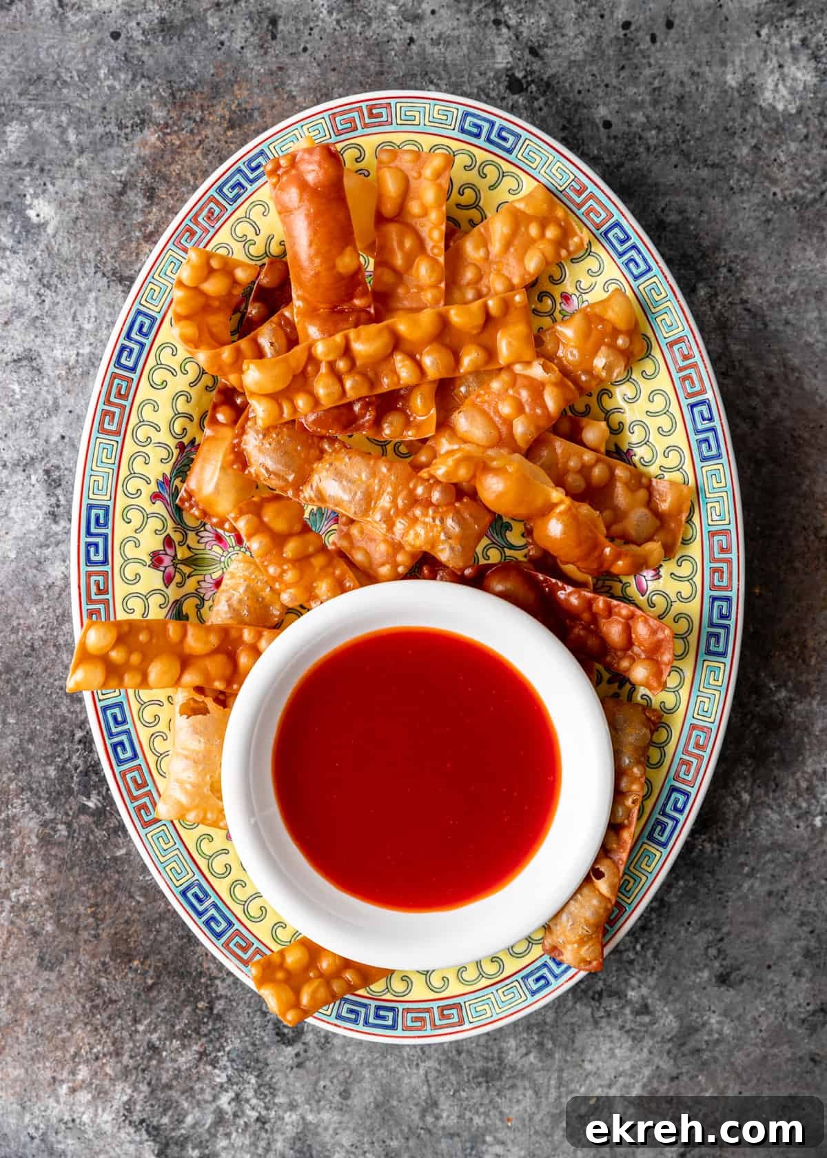 Homemade Sweet and Sour Sauce Recipe for Stir-Fries and Dipping 6 overhead: colorful platter with wonton strips and white bowl of sweet and sour sauce