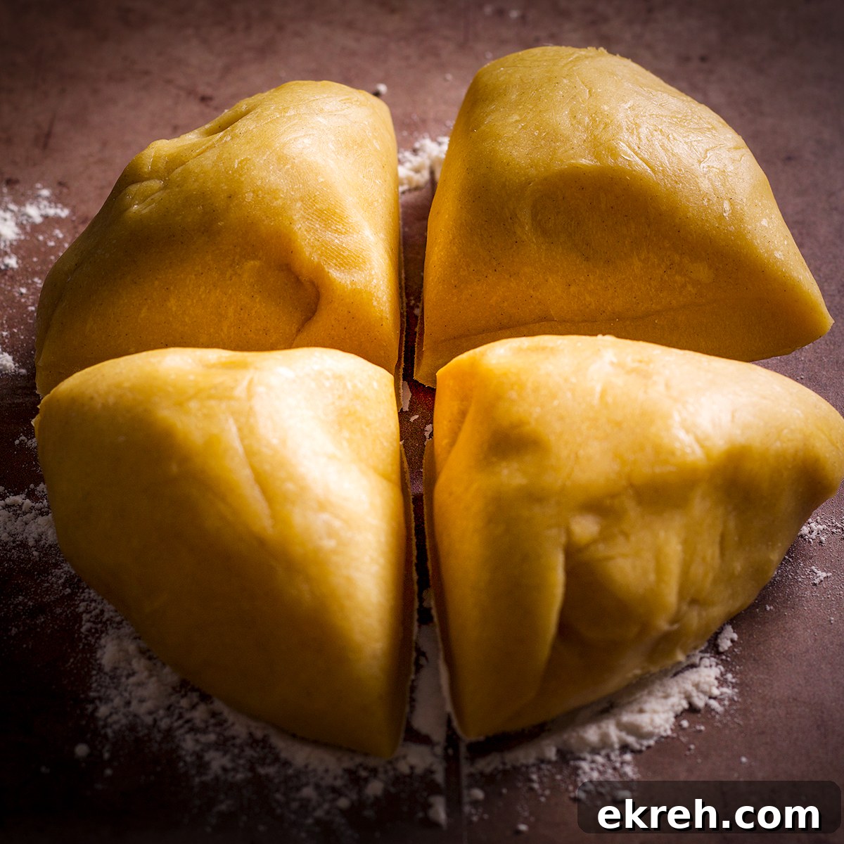 Pasta dough that's been cut into four equal pieces.