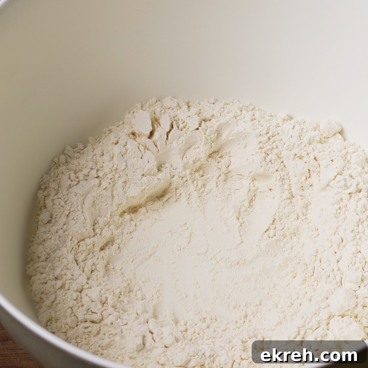 Flour in a bowl with a well in the center for egg yolks.