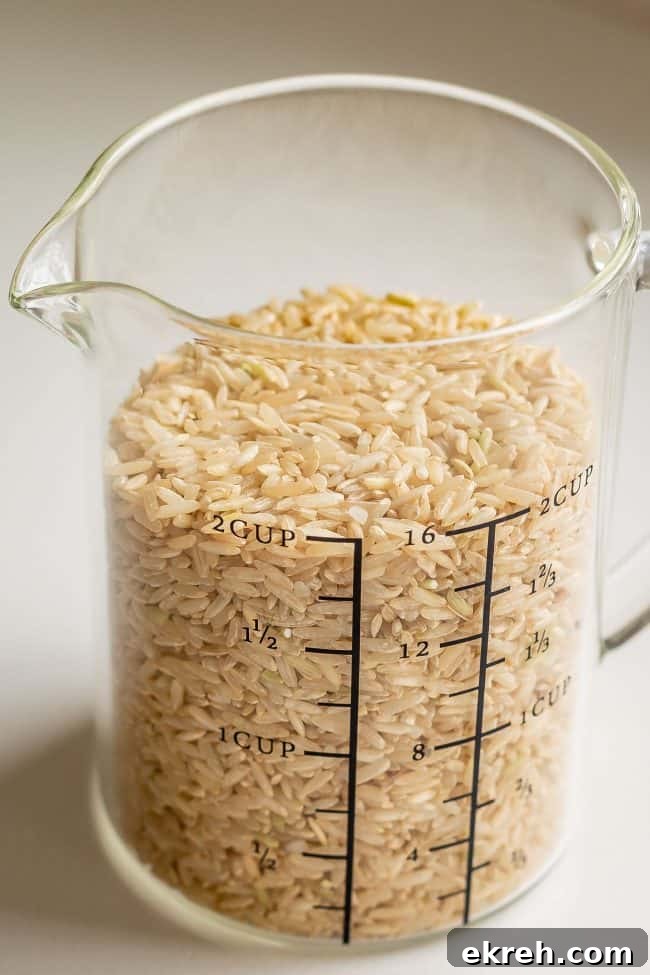 Measure Brown Rice a 2 cup measuring cup with uncooked brown rice.