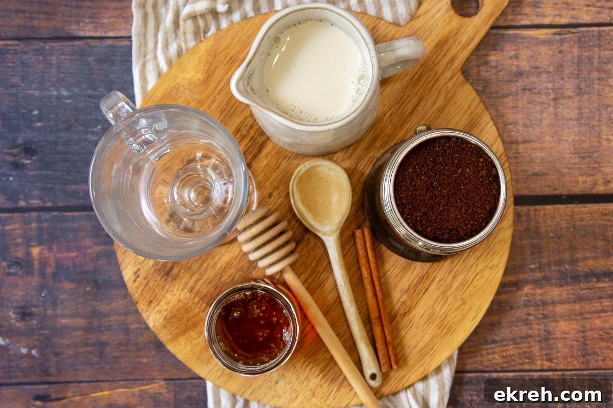 Creamy Oat Milk Honey Latte Recipe 3 Ingredients needed for an oatmilk honey latte including ground coffee, oatmilk, honey, cinnamon sticks.