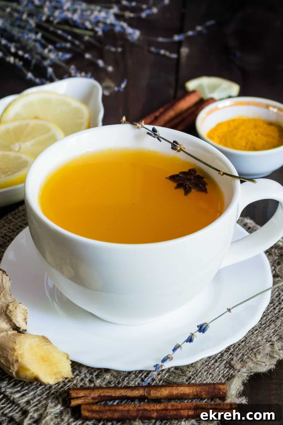 turmeric ginger tea in a white tea cup with saucer